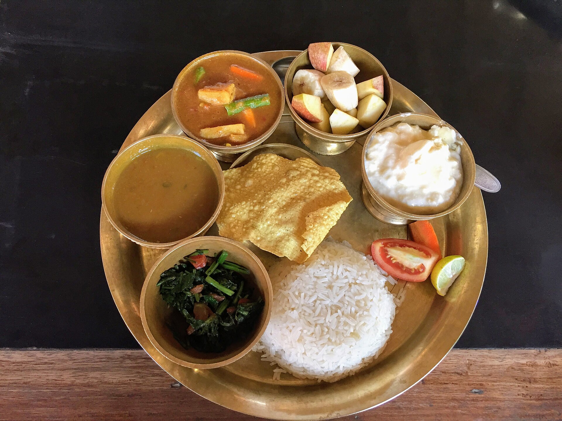 A dal bhat meal served on a metal plate