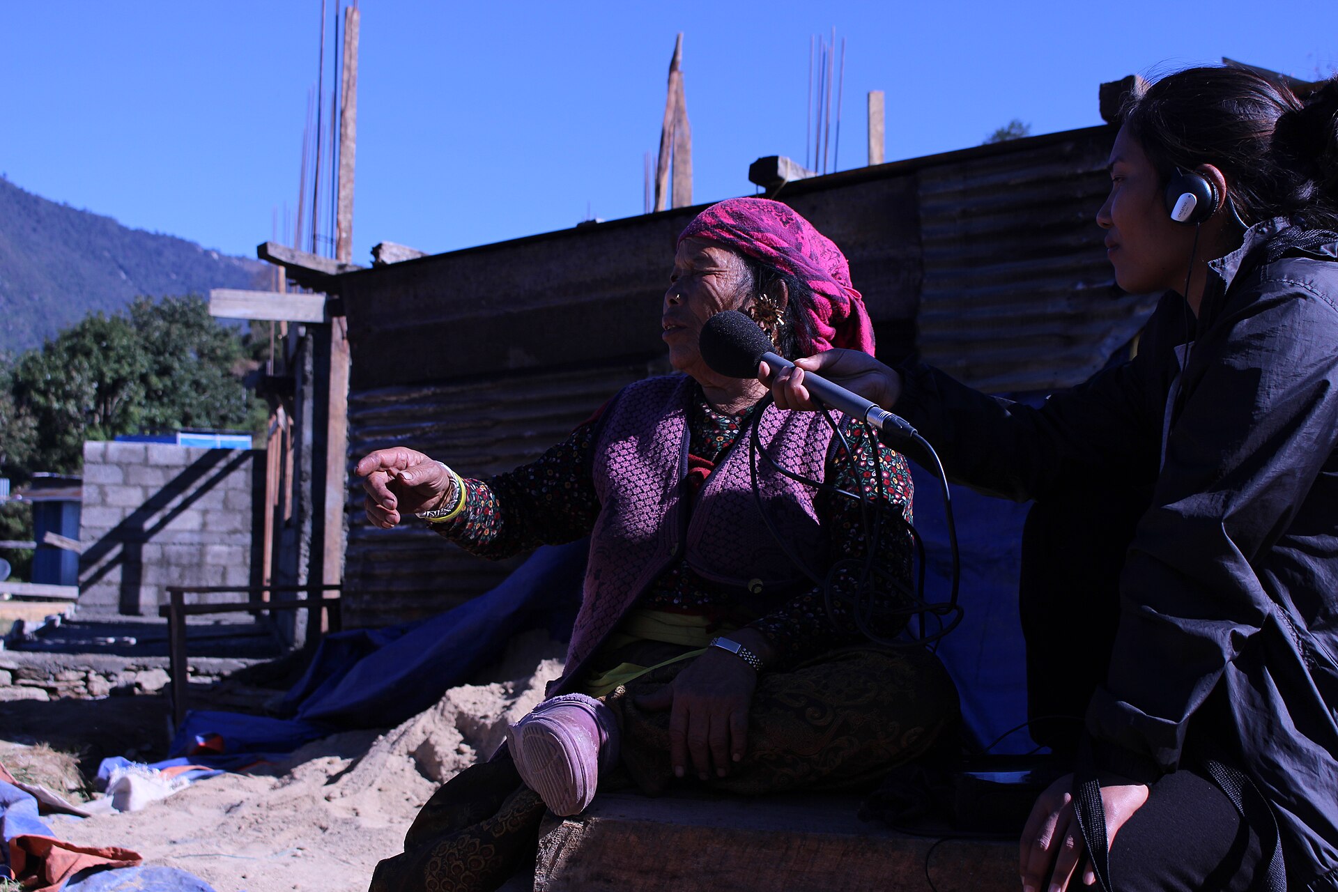 Journalists recording an interview outdoors