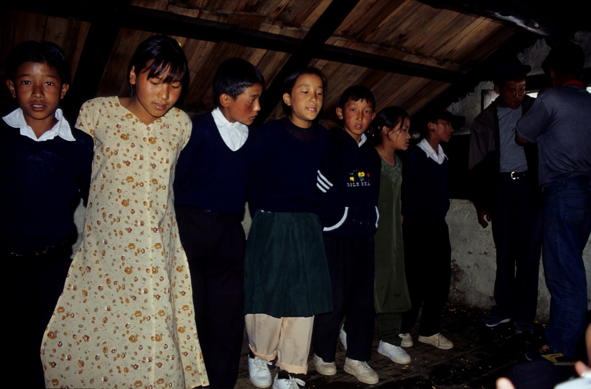 A teacher with school children outside their classroom